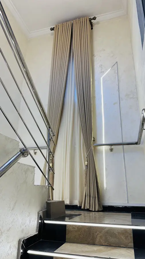Curtain fitted along a stairwell window