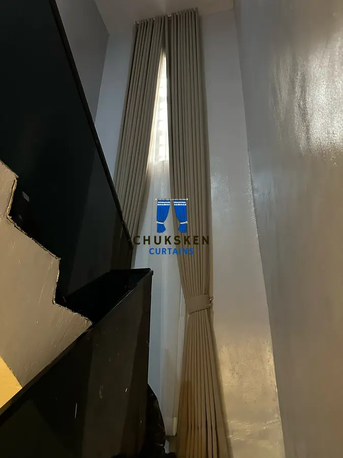 Tall curtain fitted along a stairwell window